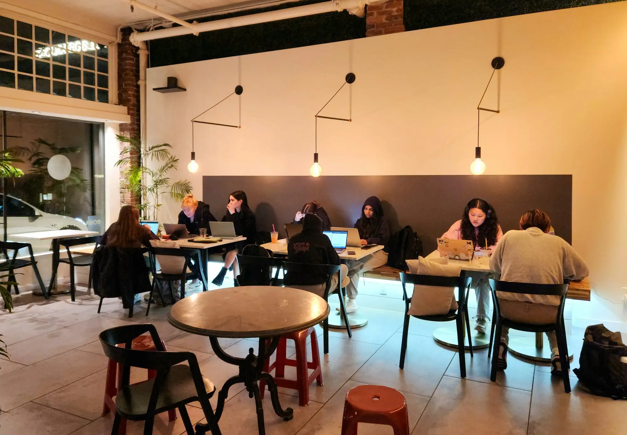 Barista serving the first customers on opening day at a small café