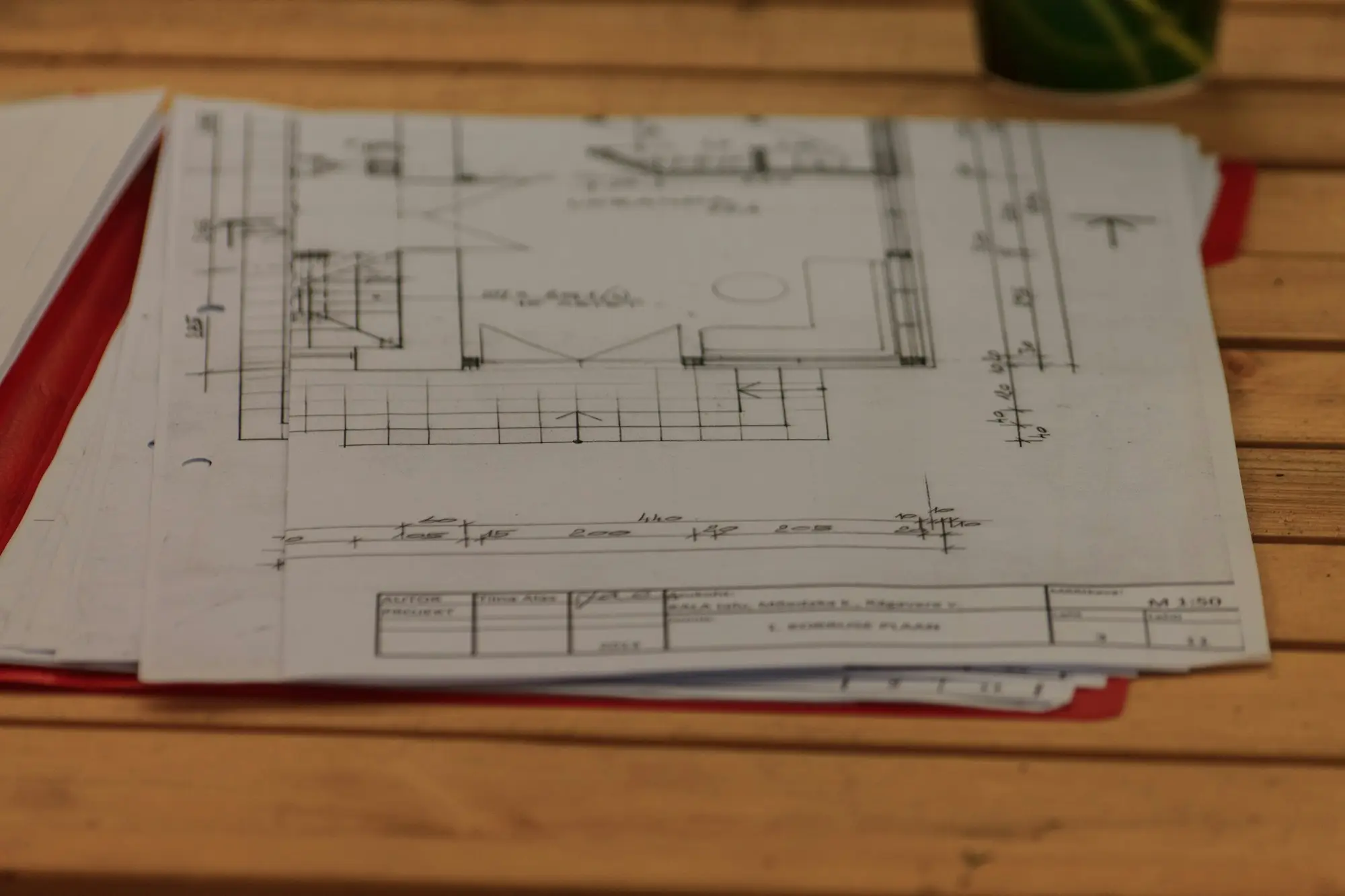 Owner and shopfitter reviewing floor plans on a half-finished counter