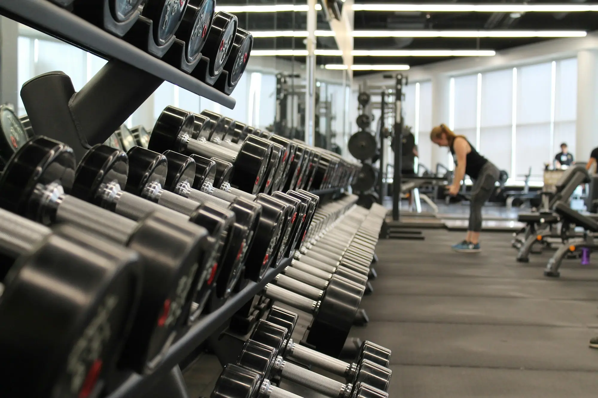 Boutique fitness studio owner wiping down new equipment before opening